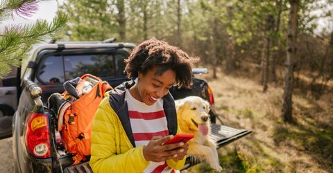 Lady checking phone while out in nature 